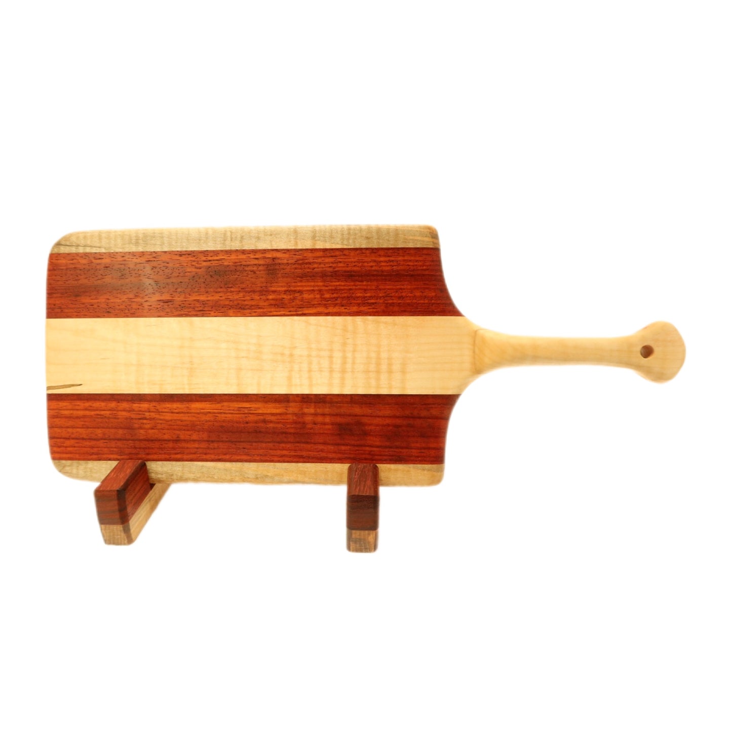 "Padauk and curly maple charcuterie board with raised handle. The board features a unique combination of warm reddish-brown padauk and light-colored curly maple, with a raised handle for easy carrying. Perfect for serving cheeses, meats, bread, crackers, fruit, and more. A stunning display piece that is sure to impress your guests."