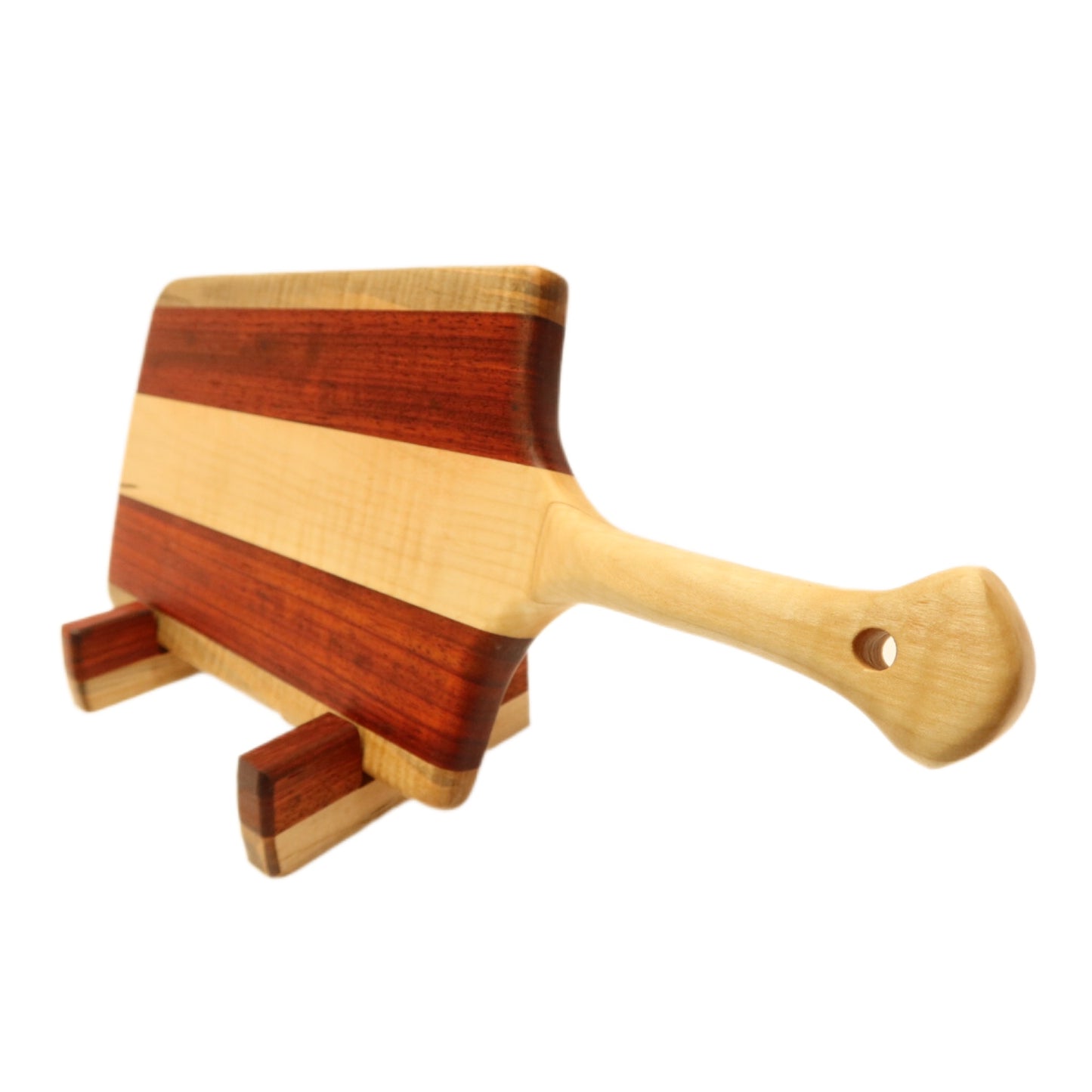 "Padauk and curly maple charcuterie board with raised handle. The board features a unique combination of warm reddish-brown padauk and light-colored curly maple, with a raised handle for easy carrying. Perfect for serving cheeses, meats, bread, crackers, fruit, and more. A stunning display piece that is sure to impress your guests."