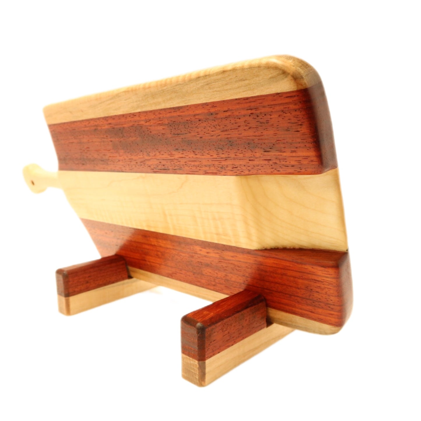 "Padauk and curly maple charcuterie board with raised handle. The board features a unique combination of warm reddish-brown padauk and light-colored curly maple, with a raised handle for easy carrying. Perfect for serving cheeses, meats, bread, crackers, fruit, and more. A stunning display piece that is sure to impress your guests."