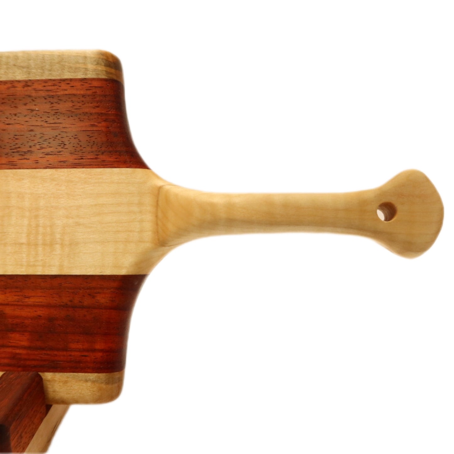"Padauk and curly maple charcuterie board with raised handle. The board features a unique combination of warm reddish-brown padauk and light-colored curly maple, with a raised handle for easy carrying. Perfect for serving cheeses, meats, bread, crackers, fruit, and more. A stunning display piece that is sure to impress your guests."